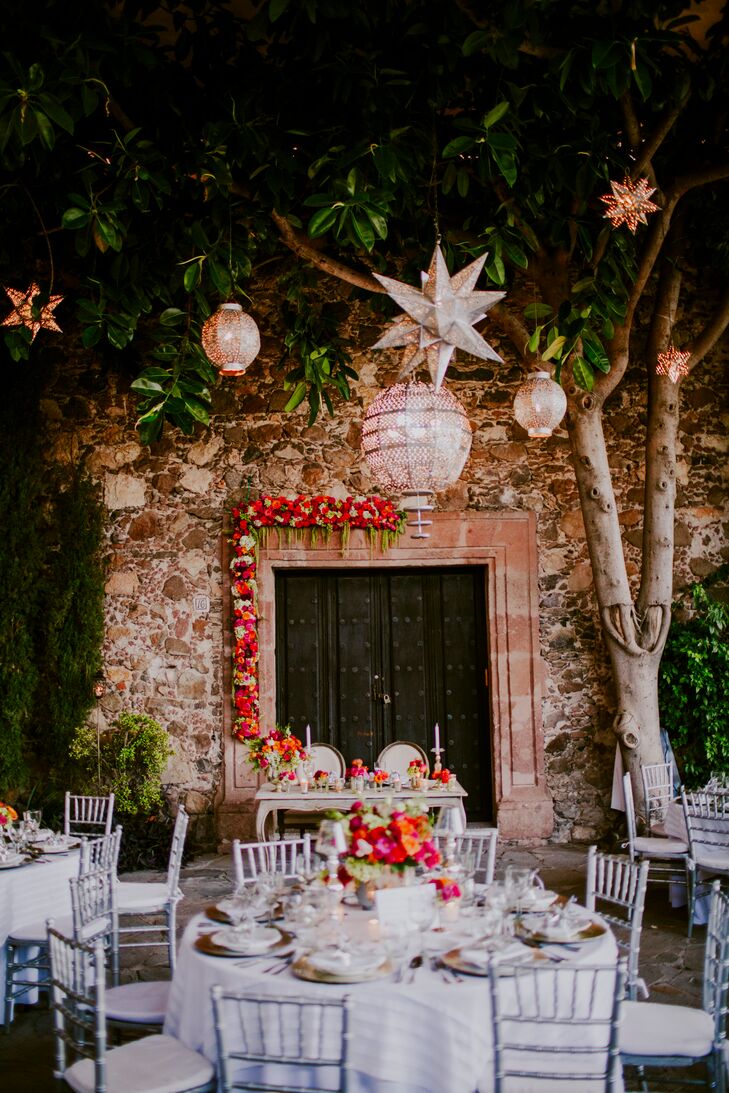 Above the elegant dressed reception tables hung dozens of silvery lanterns in a variety of shapes and styles. As the sun set over Instituto Allende, the lanterns began twinkled and glowed, casting warm, whimsical light over the outdoor reception space.