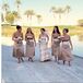 Playing up their location, Piper and Jim chose a palette of desert hues -- sage green, chocolate brown, and pale peach. Piper’s four bridesmaids wore strapless, satin tea-length dresses in taupe with champagne-colored sashes by Bill Levkoff.