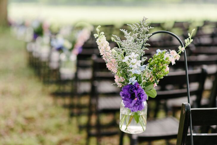 “When I was planning with our florist [Pretty Petals of Charleston, South Carolina], I explained that I was going for an organic arrangement style and wildflower look,” Elizabeth says. “She and her team did such a beautiful job, and they really captured the look I was going for. I especially loved the colorful wildflowers in mason jars hanging on shepherd's hooks lining the aisle. It looked sort of magical.”