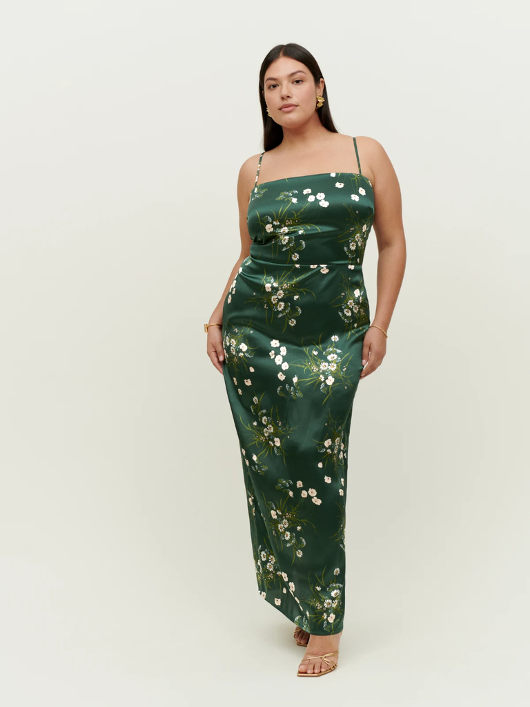 A model shows off this floor-length floral wedding guest dress.