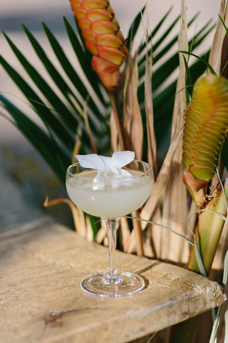Cocktail in Couple Glass With Live White Flower Garnish at Hawaiian Reception