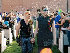 Grooms Holding Hands During Bubble Recessional