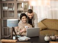 Couple using laptop at home 