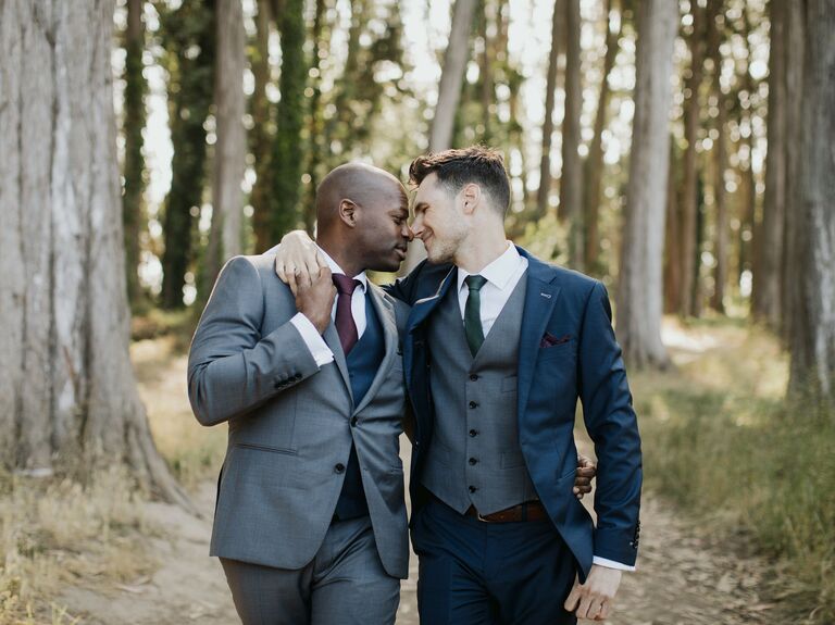 Couple embrace while wearing elegant suits. 