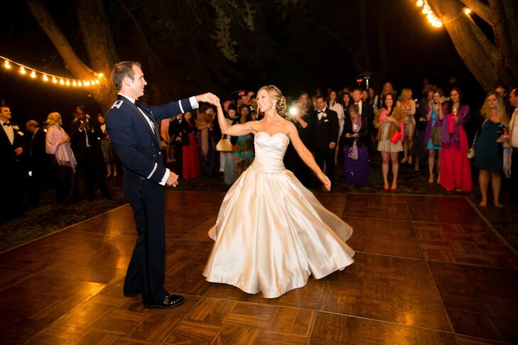 The couple shared their first dance outside on a wooden dance floor.