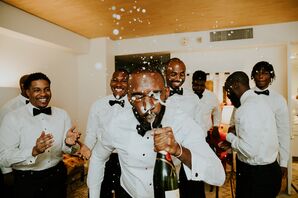 Groomsmen and Groom Getting Ready in Tuxes, Spraying Champagne in Groom's Face