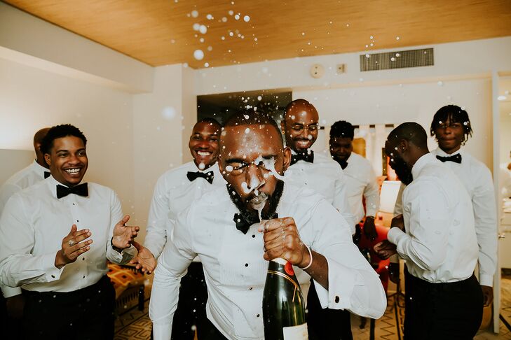 Groomsmen and Groom Getting Ready in Tuxes, Spraying Champagne in Groom's Face