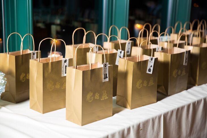 Galina and Andrew sent their guests home with custom pint glasses wrapped in gold embossed gift bags featuring their monogram and the name of each guest hand-calligraphed on the front.