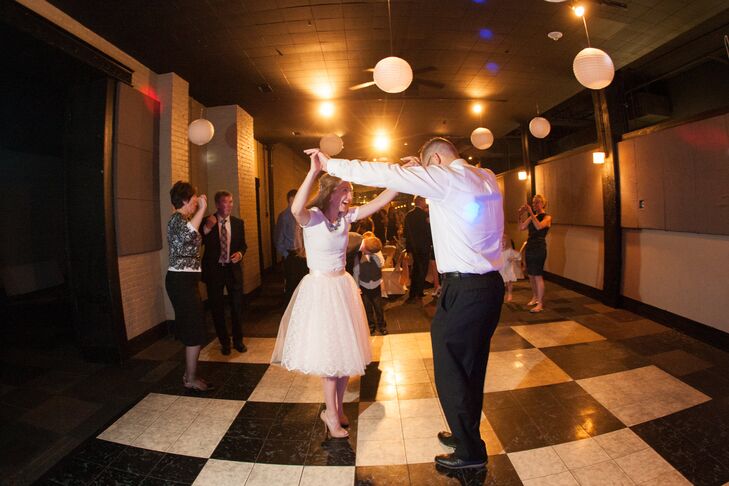 As much as Laura loved her wedding dress, she knew she couldn't dance in it and didn't want a bustle, so she changed into another look for the reception. "I changed into a 'tutu' of sorts from Space 46 Boutique in California and a J.Crew shirt that zipped up the back."