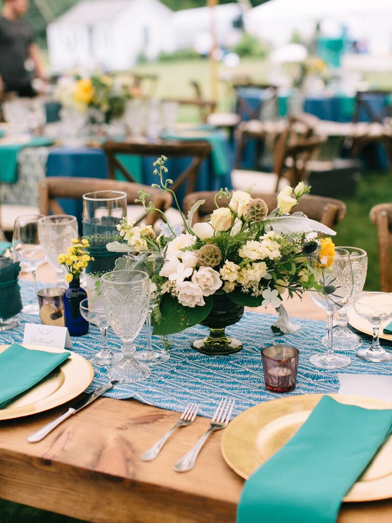 A turquoise, cream, and gold table setting.