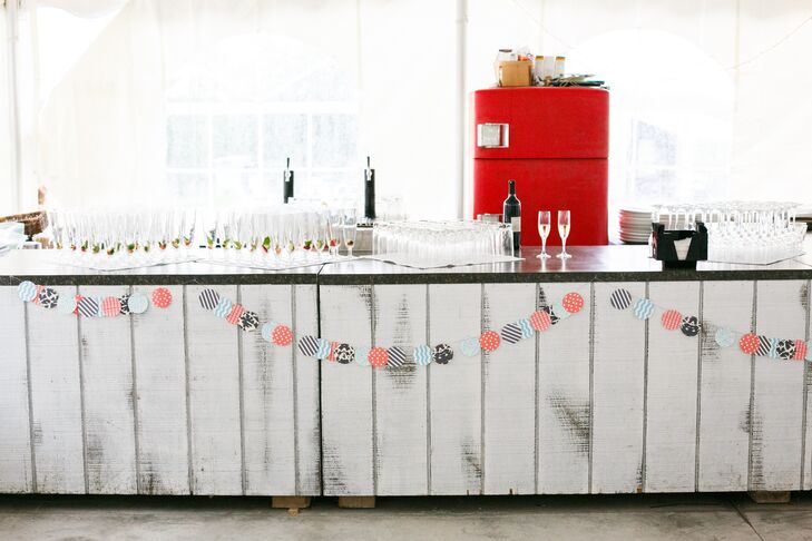 Several bold patterns in red, navy and turquoise made appearances throughout the reception, like on this paper garland decorating the bar.