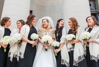 group of bridesmaids wearing white wraps