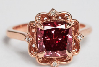 Cushion cut red diamond center with ornate rose gold halo