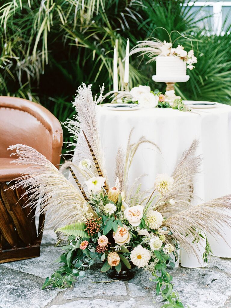 Small wedding cake with large floral arrangement