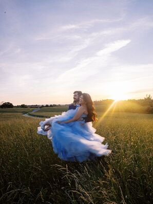 Sunset Photo of Bride in Blue Dress Dancing in Field