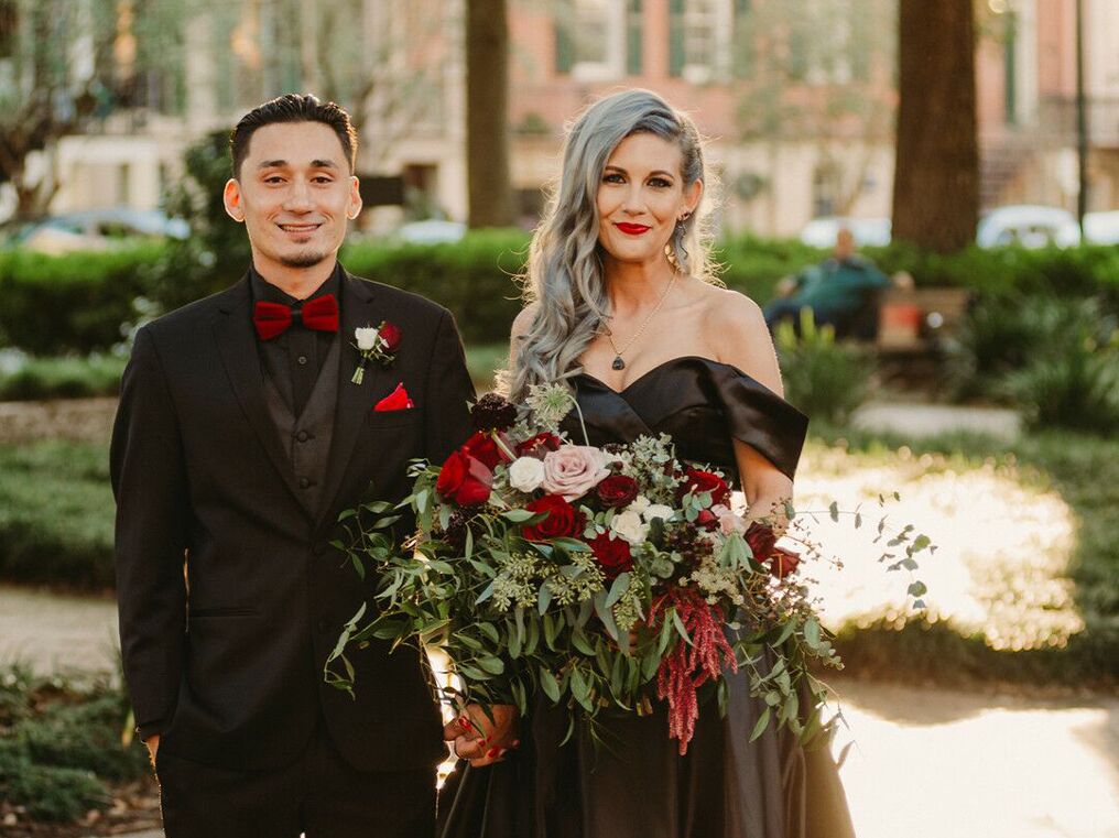 Couple dressed in black at their Halloween-themed wedding