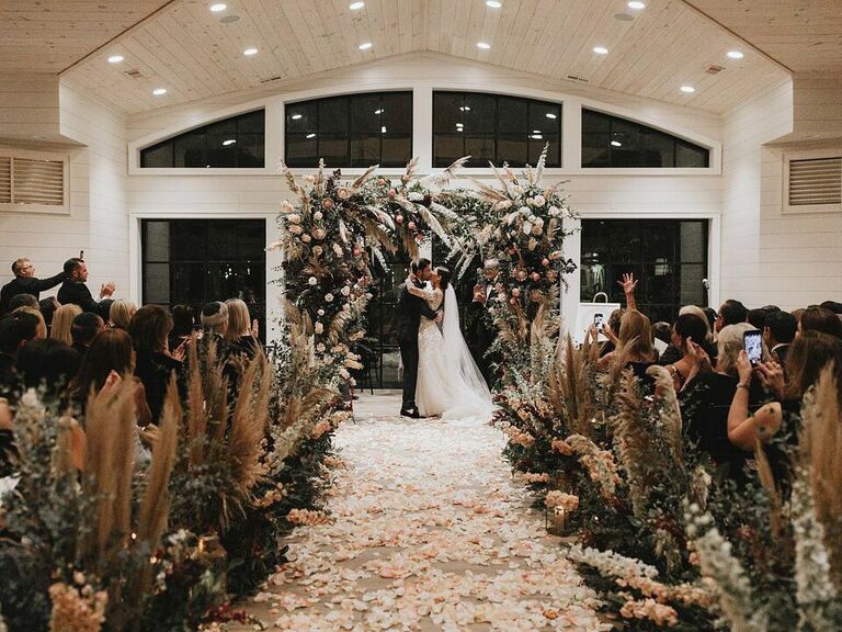 Oversized fairytale wedding arch with greenery and flowers 