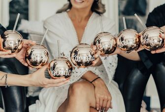 Bride and bridesmaid toasting personalized bridesmaid gift globe cups