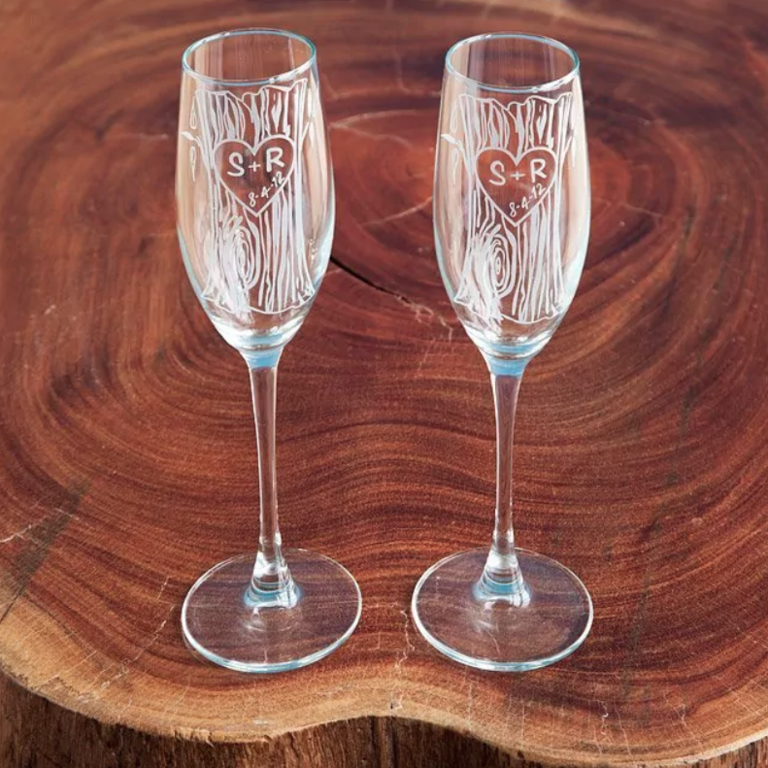 engraved wedding champagne flutes with tree trunk pattern and initials carved into a heart