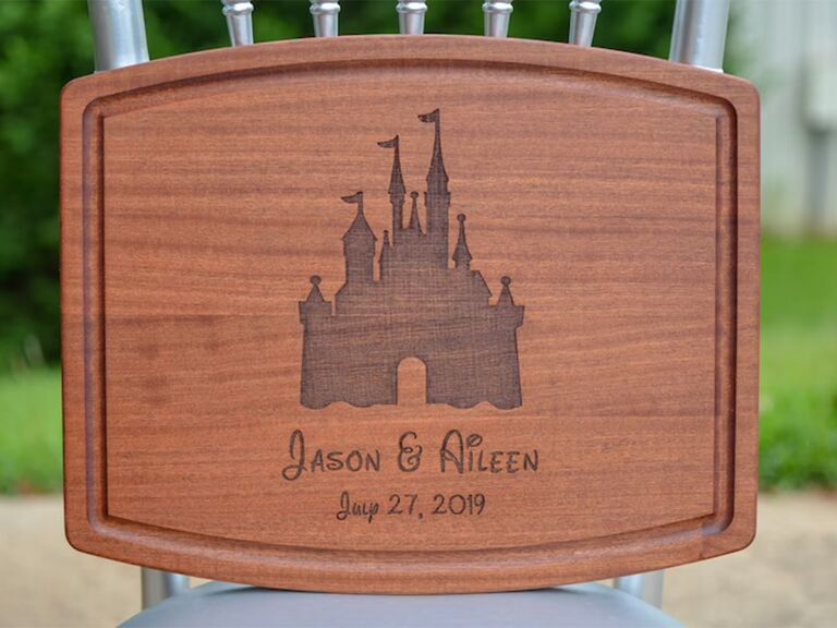Wooden cutting board with Cinderella castle carving and personalized couple's names and wedding date