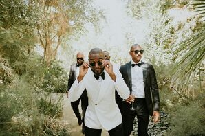 Groom in White Tuxedo Jacket Leading Groomsmen Through Trees, Garden With Sunglasses, Playful