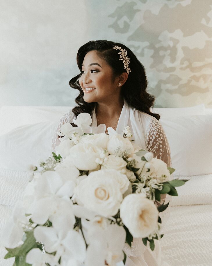 Bride Holding White Bouquet With Orchids and Ranunculus