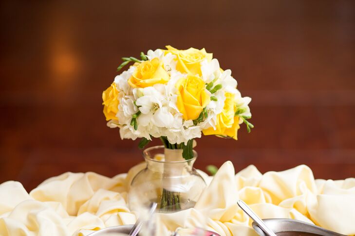 At the reception, Britni repurposed her yellow rose bouquet as a centerpiece by placing it in a glass vase.