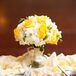 At the reception, Britni repurposed her yellow rose bouquet as a centerpiece by placing it in a glass vase.
