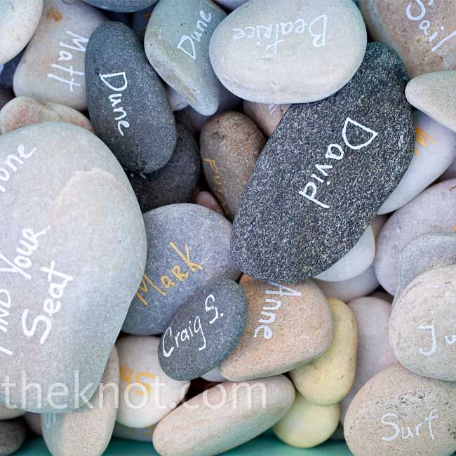 For a nontraditional spin on escort cards, the couple gathered smooth stones from the beach and wrote the guest’s first name on one side and the table name on the other.