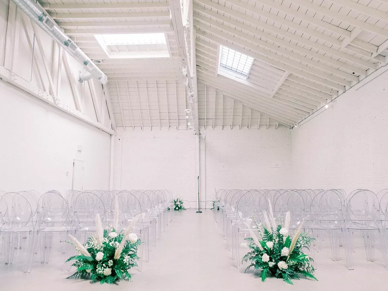 A beautiful wedding ceremony site complete with see-through chairs.
