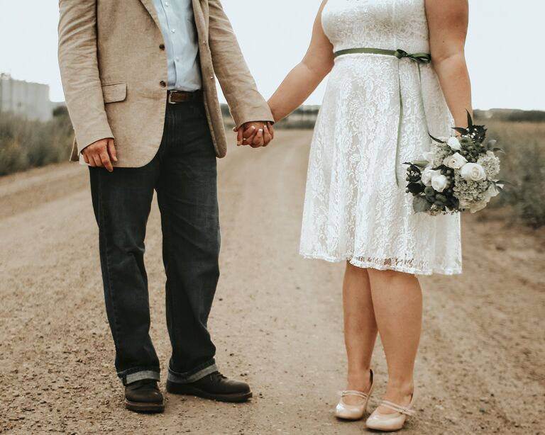 Bride and groom holding hands
