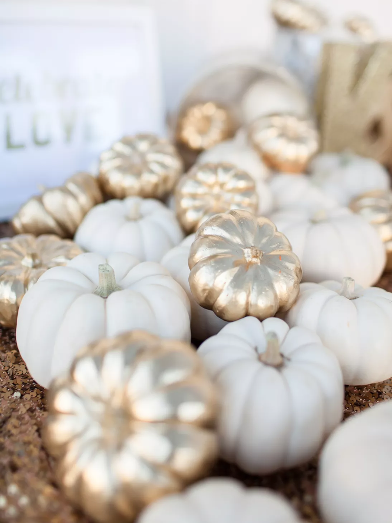 Delightful ghost pumpkins and gold-painted pumpkins.