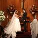 For her traditional Catholic ceremony, Kieran wore a cathedral veil with lace trim that looked beautiful with her simple ball gown. The altar at the wood-paneled church was decorated with white flower arrangements of roses, ranunculus, hydrangeas and delphiniums.