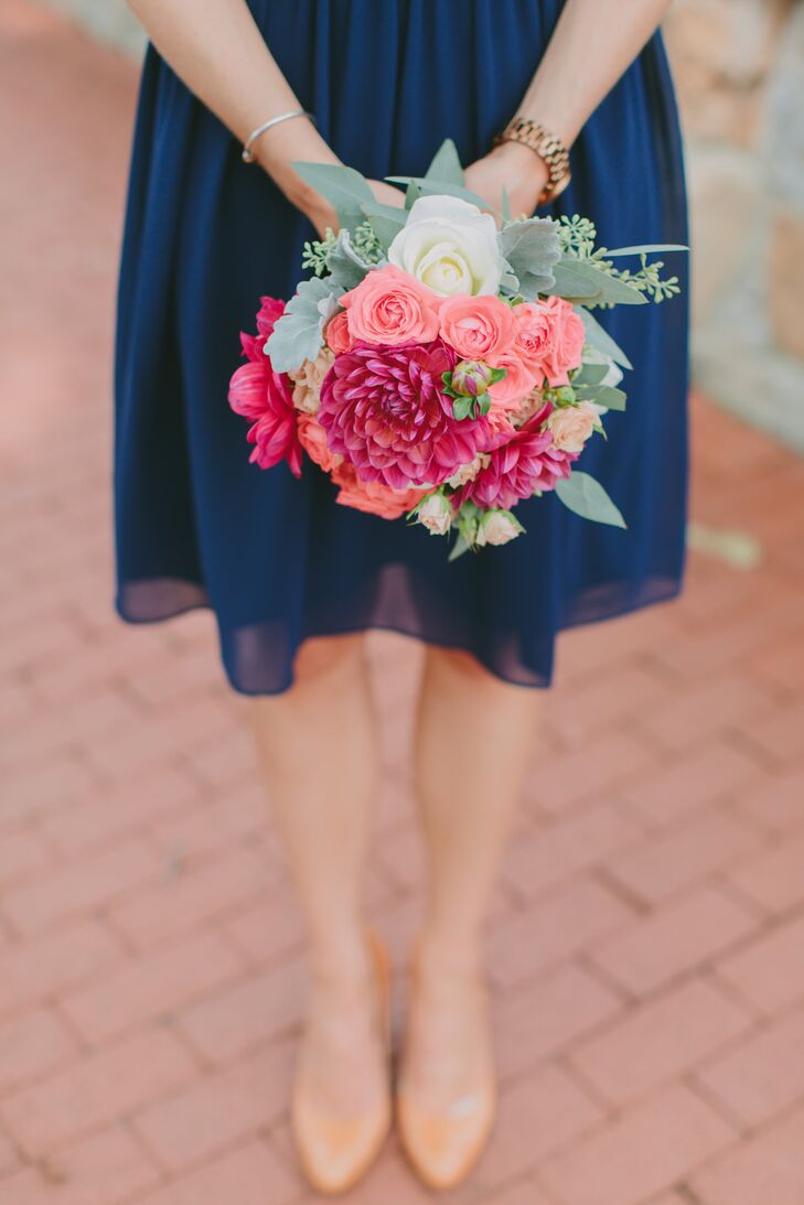 Bridesmaids carried bouquets with a variety of coral-toned flowers, including spray roses, garden roses, dahlias, succulents, dusty miler and eucalyptus.