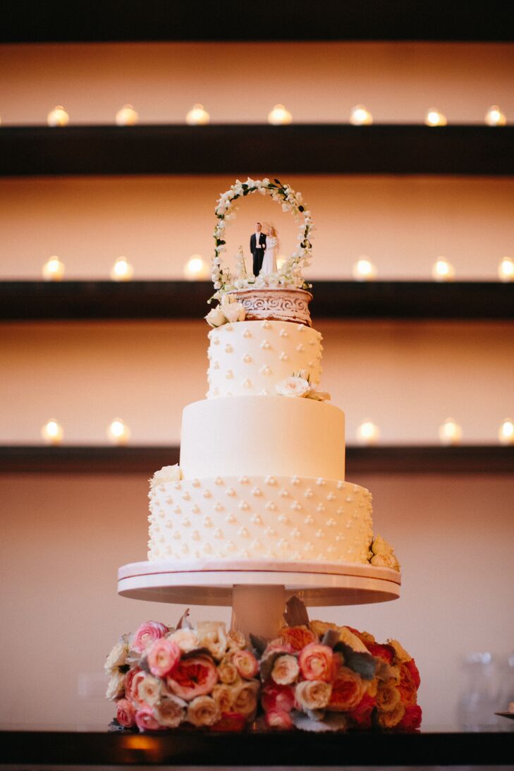 "We chose a carrot cake with cream cheese frosting to really emulate the taste of fall," Liz says. "Plus, it's our favorite!" The three-tier confection sported a delicate swiss dot piped detail as well as a cake topper that once belong to the bride's mother and grandmother. "It's now engraved with three generations of wedding dates!" the bride explains.