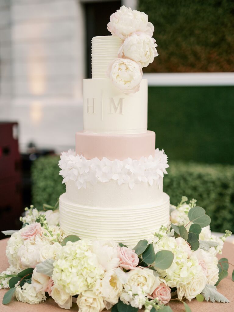 four tier fondant wedding cake with blush peonies and monogram
