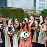 bride and wedding party laughing 