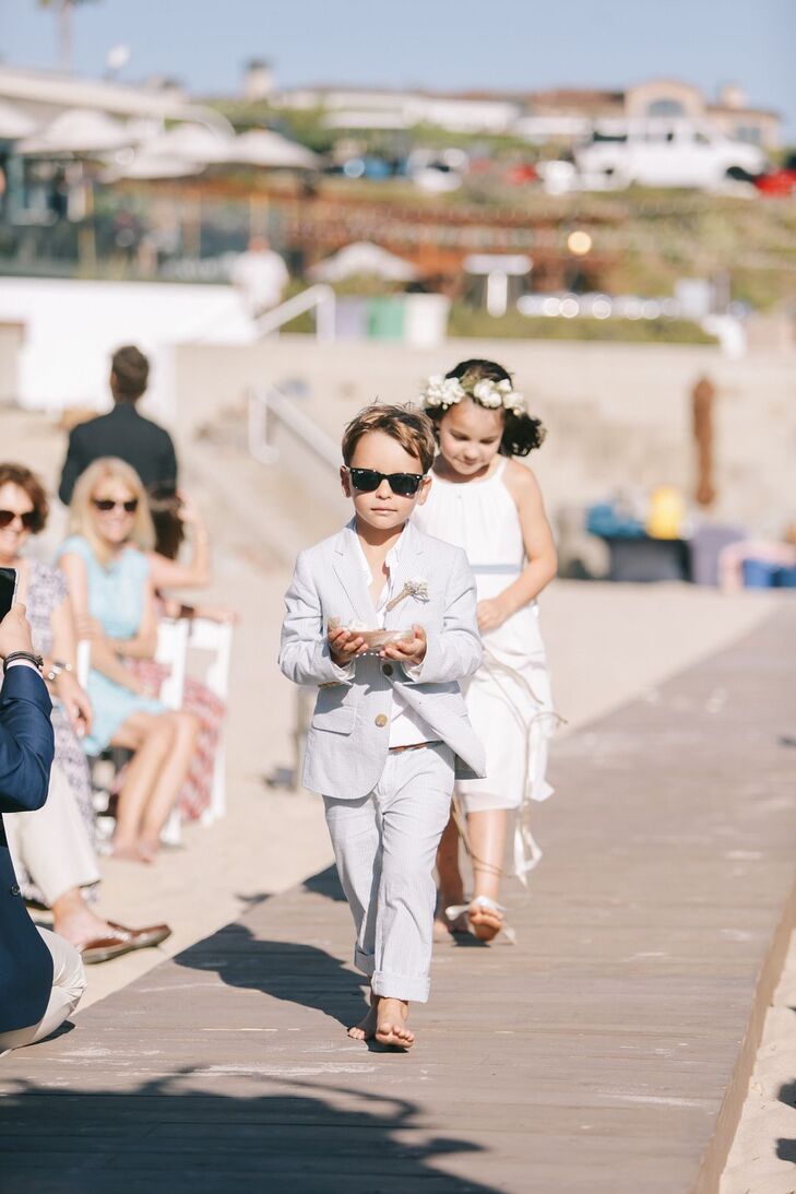 Flower girls and the ring bearer were outfitted with sunglasses and beachy, light-toned apparel.