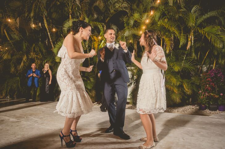 Since heat and random rainstorms in Florida are common, Roxy knew she wanted a second dress for the reception. She picked out a tiered ivory Tracy Reese dress just to hit the dance floor in. "It ended up being a wise choice since I got my wedding dress soaked dancing in the rain," she says.