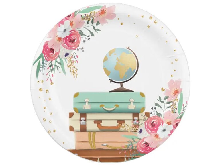 Paper plate with pink and white florals, gold flecks and globe and luggage graphics