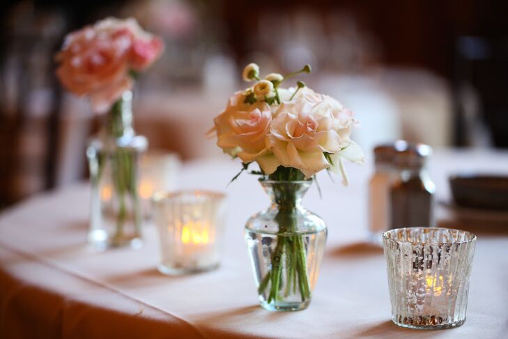 Centerpieces were small arrangements of pink spray roses in bud vases and mason jars with surrounding tea light candles in glass and mercury votives.