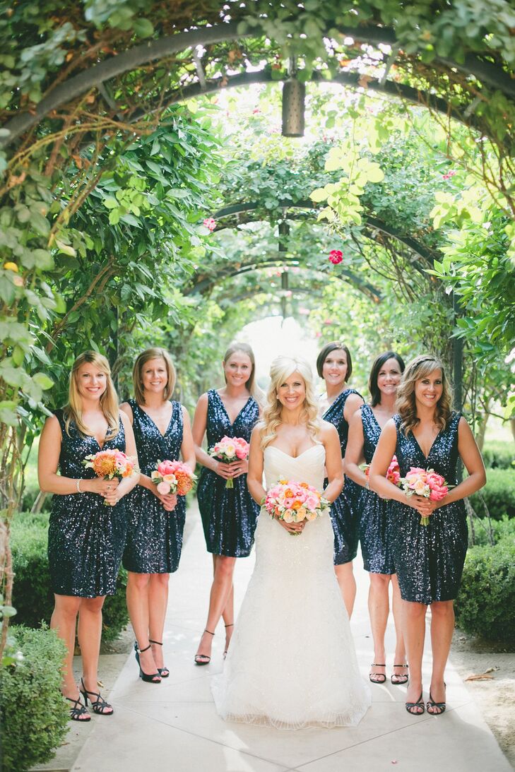 The bridesmaids wore navy sequined dresses by Badgley Mischka, which Kendrick found on Rent the Runway. The shimmery dresses tied into the wedding's glam theme and complemented the sequined linens and glittery accents found throughout the reception.