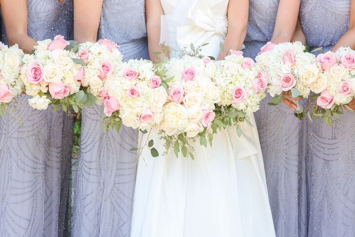 Bridesmaids carried matching miniature versions of Lauren's bouquet—an arrangement that included ivory roses, hydrangeas and pink blooms.