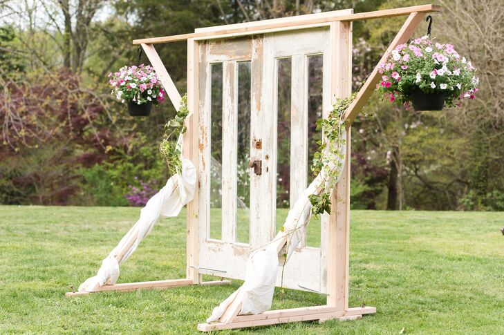 Now this is the definition of country. Rachael and Korey walked through a pair of wooden doors for their ceremony entrance. Ivy and these sweet hanging arrangements of light pink petunias decorated the accent.