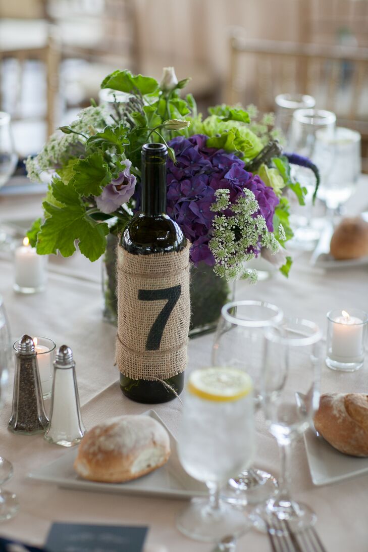 Lauren and Richard are both creative people and wanted to create a lot of the decor used at their wedding. They created their table numbers using wine bottles with burlap and stenciled numbers.