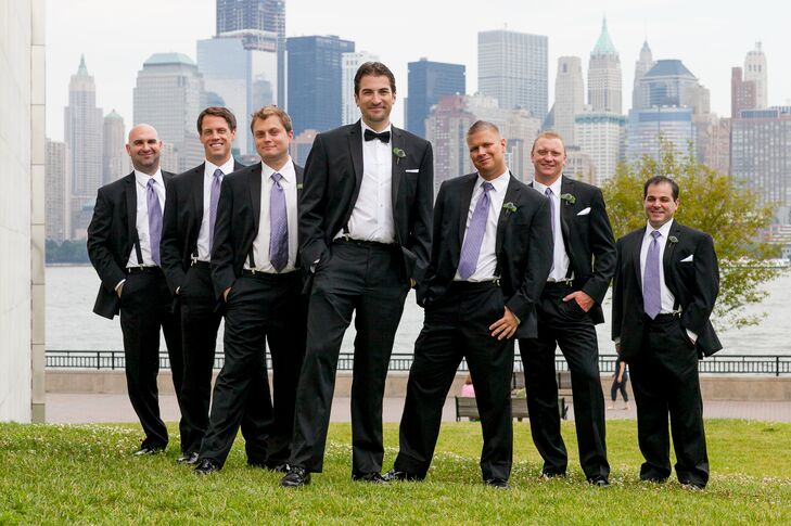 Richard and his groomsmen wore classic black tuxedos from Men's Wearhouse. While Richard wore a black bow tie, his groomsmen wore lavender ties that paired perfectly with the navy bridesmaid dresses and the blue and purple flowers used throughout the day.