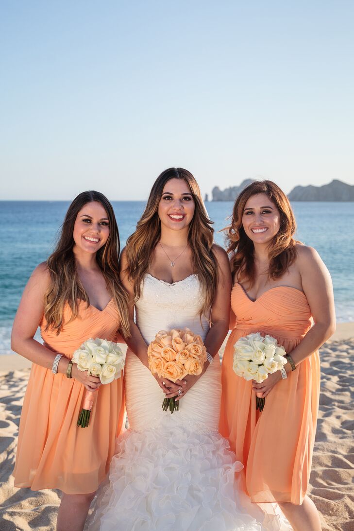 Light orange bridesmaids dresses look so pretty on the beach with the blue ocean backdrop. Maria and Maxwell incorporated this color throughout their wedding, even in Maria's light orange rose bouquet.