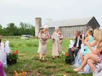 Grandmother flower girls wearing taupe dresses with printed capelets