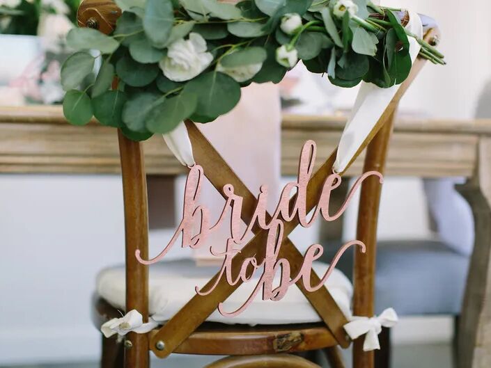 A "bride to be" chair backer.