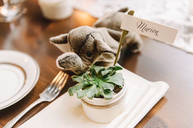 Guests found their seats marked with their names on small white labels, which stuck out from potted succulents set on top of white napkins.